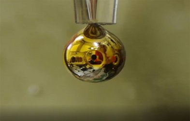 Water transformed into shiny, golden metal